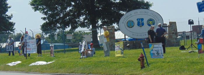 In front of the Air Base sign
